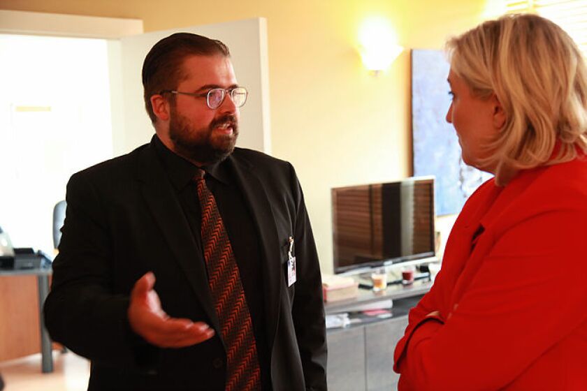 Alexandre Cormier-Denis speaking to Marine Le Pen.